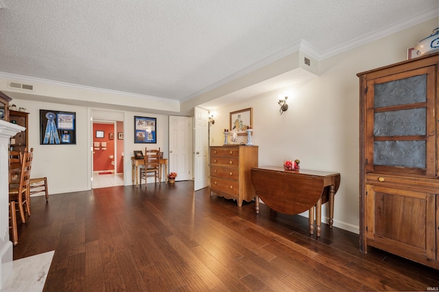 living area with crown molding, dark hardwood / wood-style flooring, and a textured ceiling