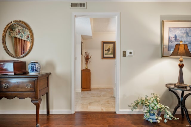 hallway with hardwood / wood-style flooring and crown molding