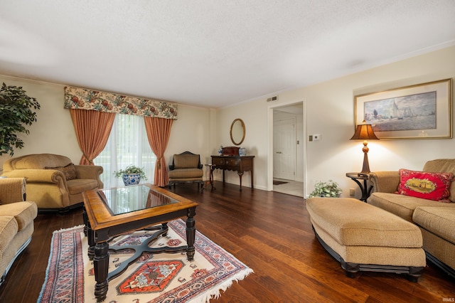 living room with a textured ceiling, dark hardwood / wood-style flooring, and crown molding