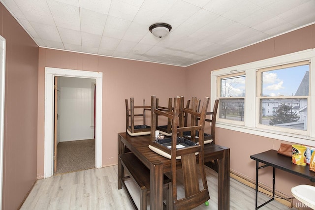 dining space with light hardwood / wood-style flooring