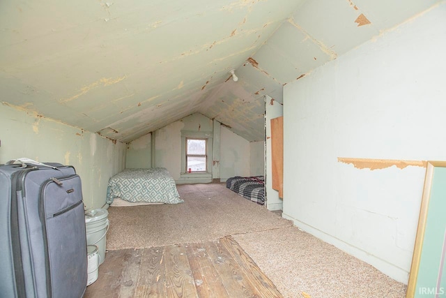 bonus room with carpet flooring and vaulted ceiling