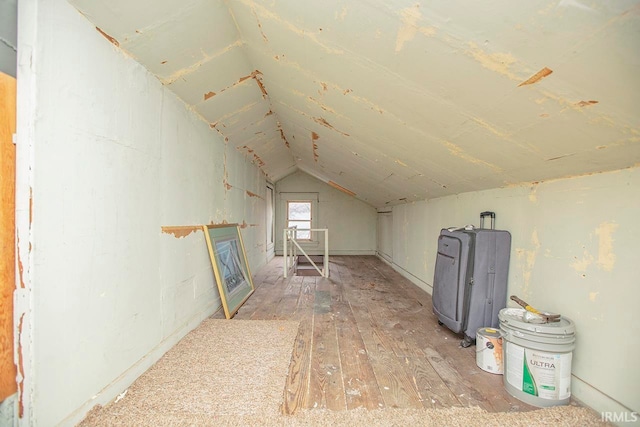 additional living space featuring light hardwood / wood-style floors and vaulted ceiling