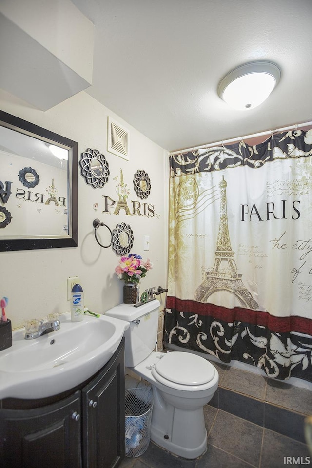 bathroom with vanity, tile flooring, and toilet