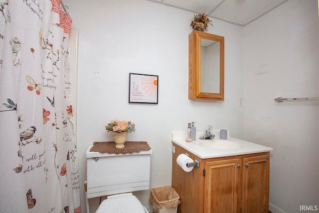 bathroom with vanity with extensive cabinet space and toilet