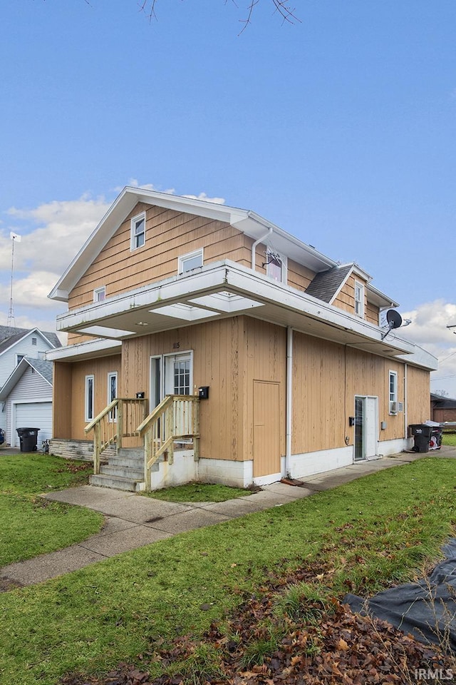 view of front of house with a front yard, covered porch, and a garage