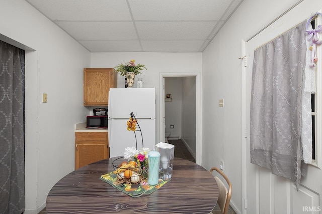 dining room with a drop ceiling