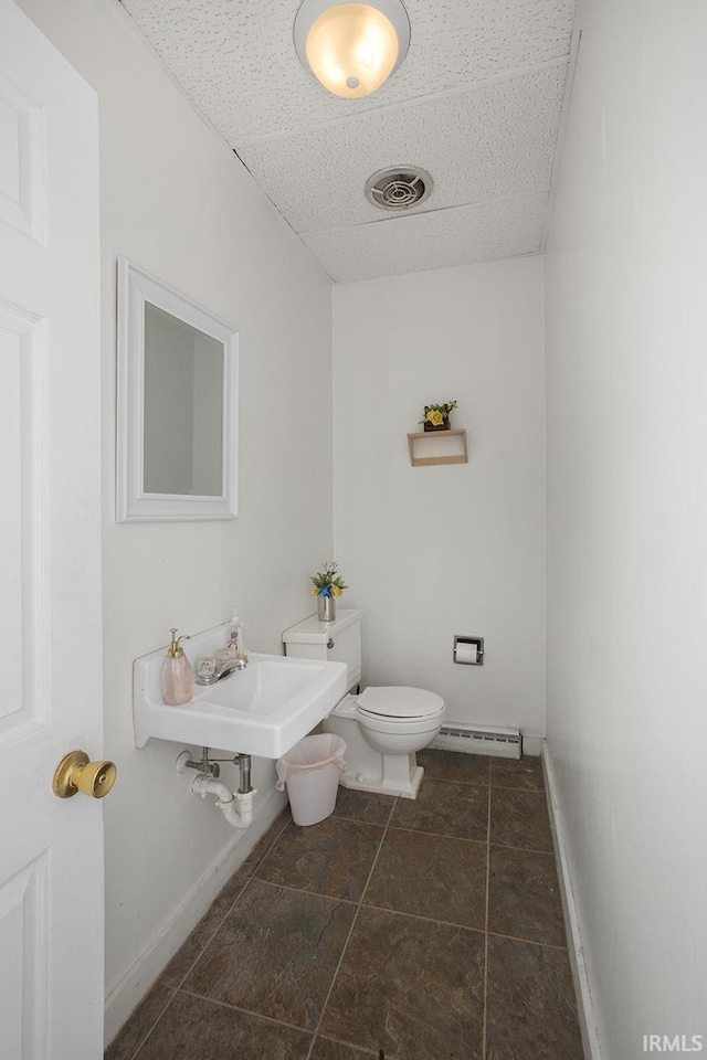 bathroom featuring toilet, a baseboard radiator, sink, and tile flooring