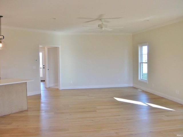 unfurnished room featuring light hardwood / wood-style floors, ceiling fan, and crown molding