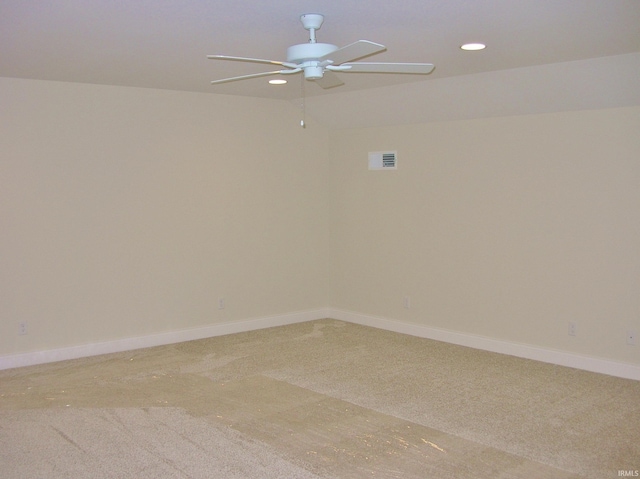 carpeted spare room with ceiling fan