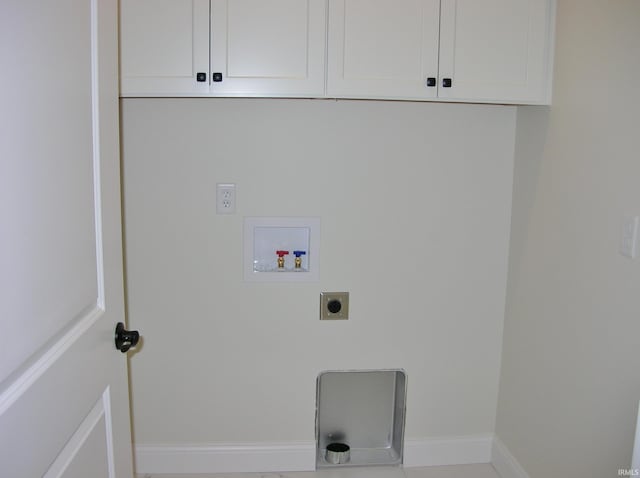 clothes washing area featuring cabinets, hookup for a washing machine, and electric dryer hookup