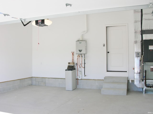 garage with a garage door opener and water heater