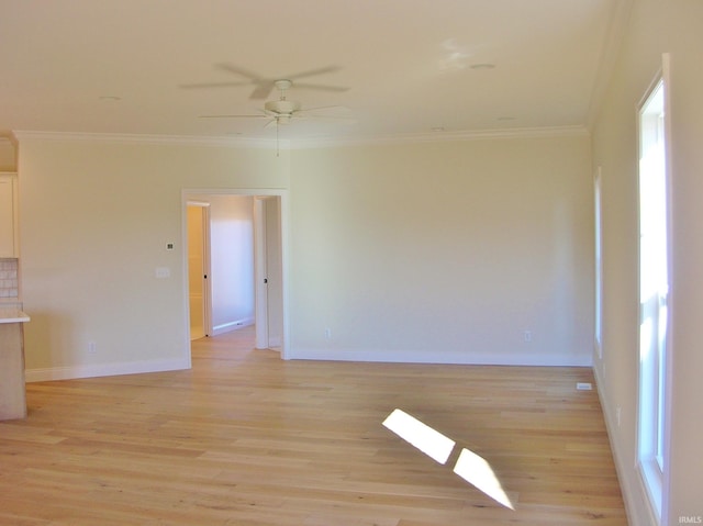 spare room with light wood-type flooring, ceiling fan, and ornamental molding