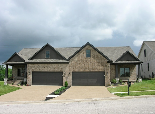 craftsman house featuring a garage and a front yard