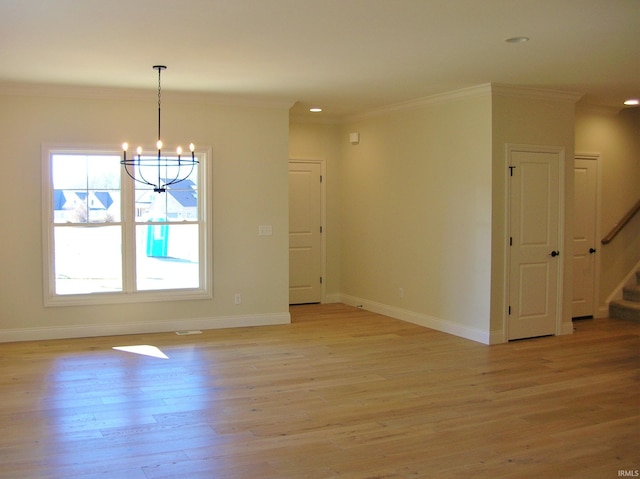 unfurnished room featuring crown molding, an inviting chandelier, and light wood-type flooring