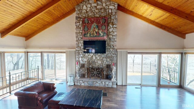 living room featuring dark hardwood / wood-style floors, wood ceiling, and a stone fireplace