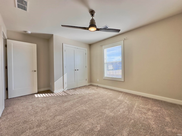 unfurnished bedroom with a closet, light carpet, and ceiling fan