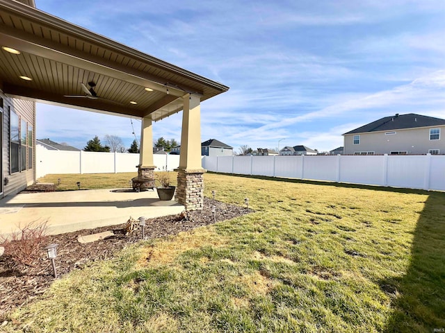 view of yard featuring a patio area and ceiling fan