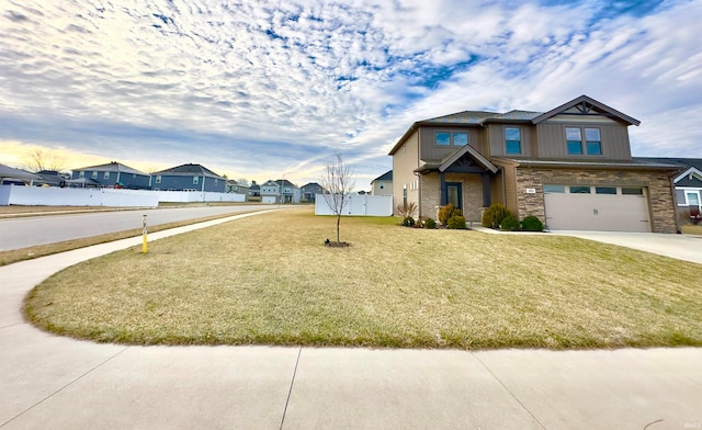 craftsman house featuring a front yard and a garage