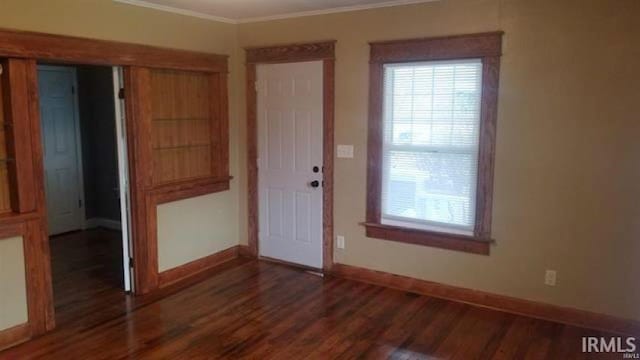 unfurnished room featuring crown molding and dark hardwood / wood-style floors