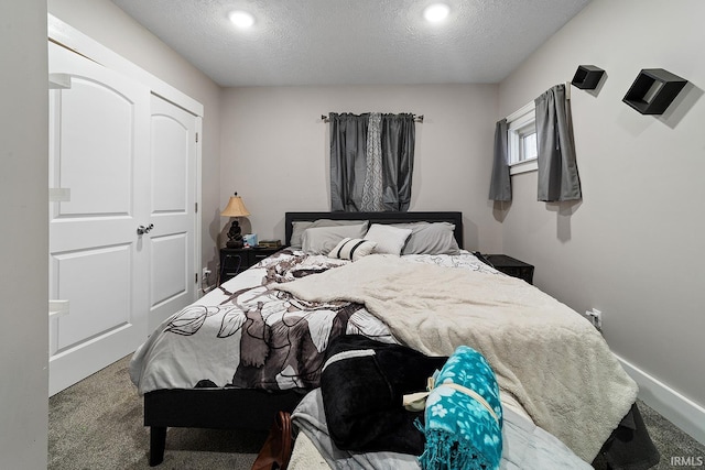 carpeted bedroom with a textured ceiling