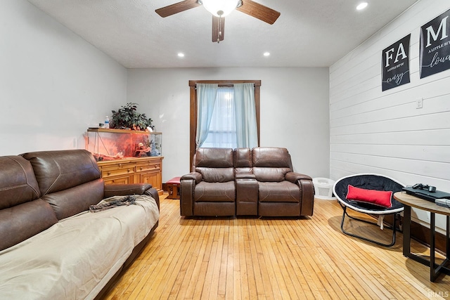 living room featuring ceiling fan and light hardwood / wood-style flooring