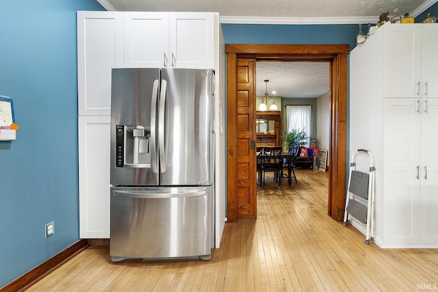 kitchen with decorative light fixtures, a textured ceiling, light hardwood / wood-style flooring, white cabinetry, and stainless steel refrigerator with ice dispenser