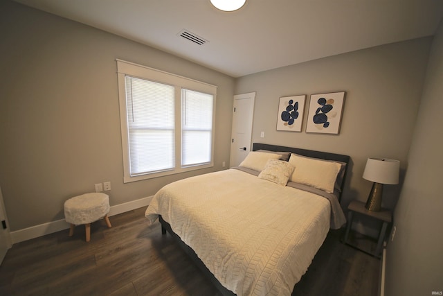 bedroom with dark hardwood / wood-style flooring