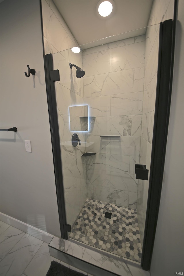 bathroom with tile flooring and a tile shower