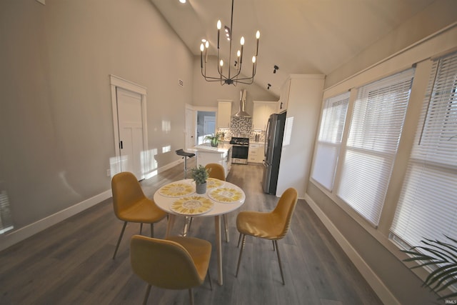 dining area with dark hardwood / wood-style flooring, an inviting chandelier, and a wealth of natural light