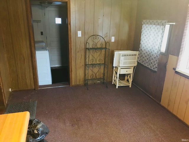 miscellaneous room with washer / clothes dryer, wooden walls, a wall mounted air conditioner, and dark colored carpet