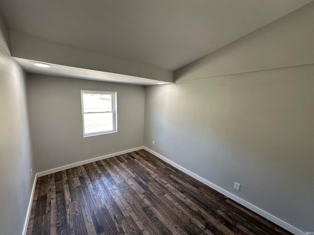 spare room with dark wood-type flooring