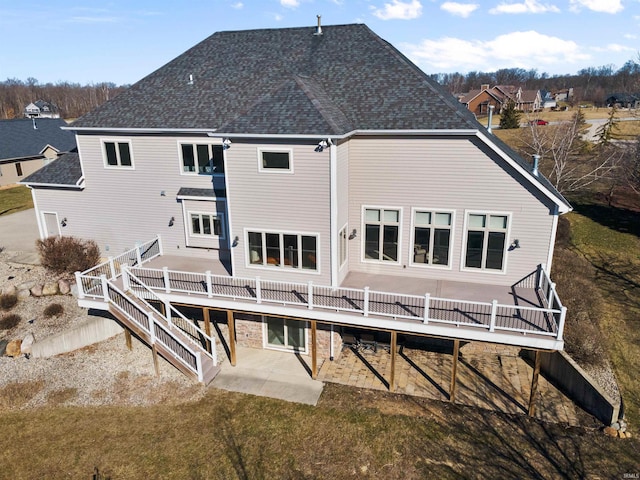 back of property featuring a patio area and a wooden deck