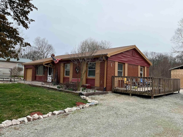 single story home featuring a deck and a front yard