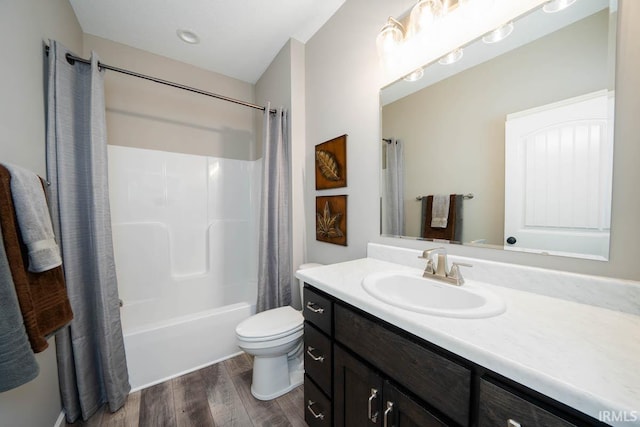 bathroom featuring vanity, shower / tub combo, toilet, and wood finished floors