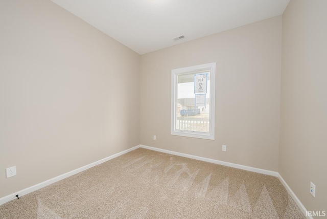 unfurnished room with light colored carpet, visible vents, and baseboards