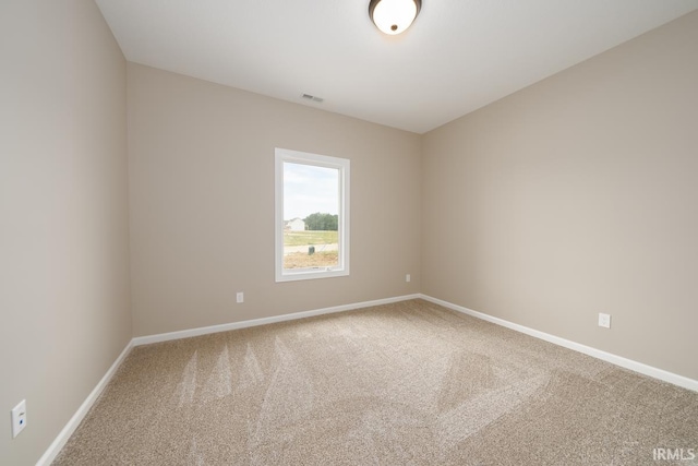 carpeted empty room with baseboards