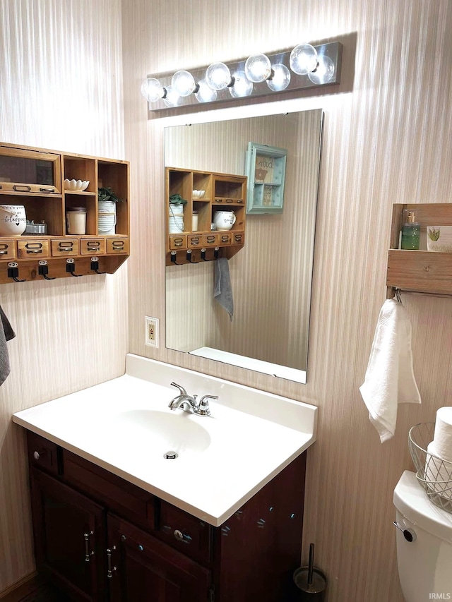 bathroom with toilet and vanity