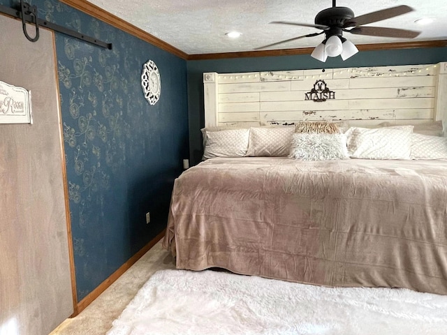 bedroom featuring ceiling fan, ornamental molding, carpet, and a textured ceiling