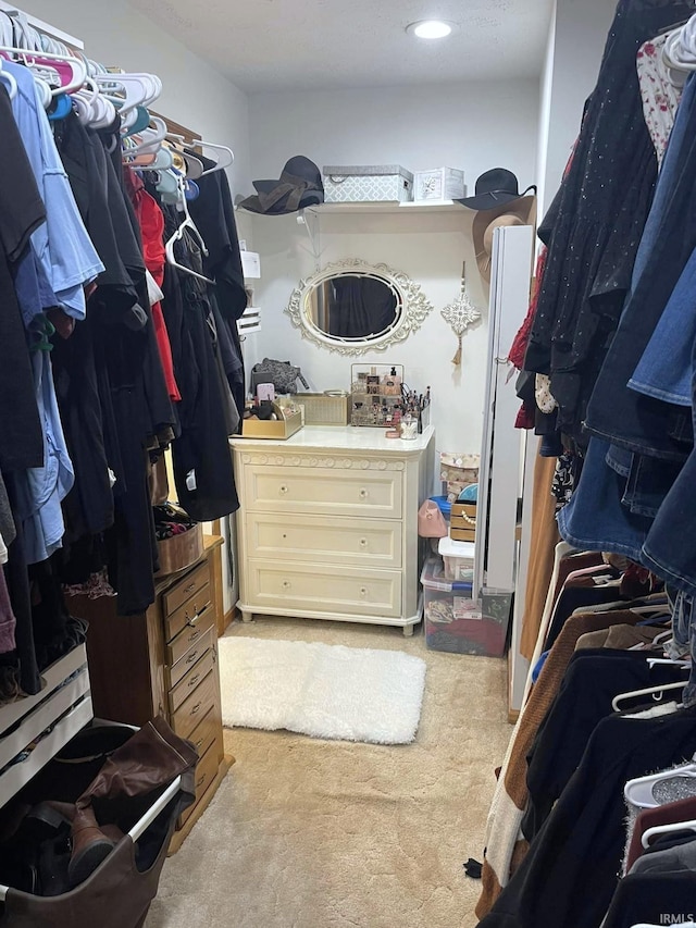 spacious closet featuring light carpet