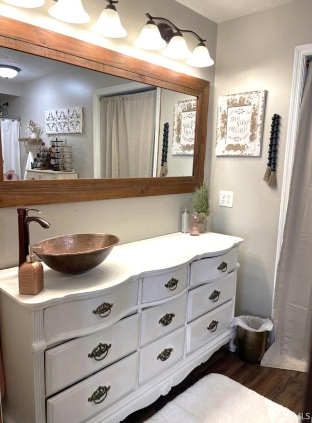 bathroom with vanity and wood-type flooring