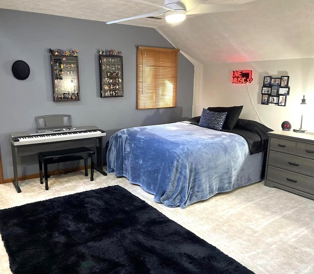 bedroom with lofted ceiling, ceiling fan, light colored carpet, and a textured ceiling