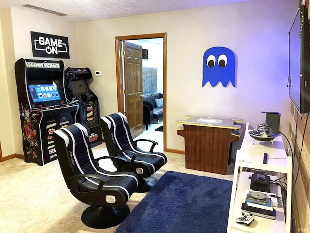 sitting room with light colored carpet and a textured ceiling