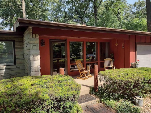 view of exterior entry with a garage