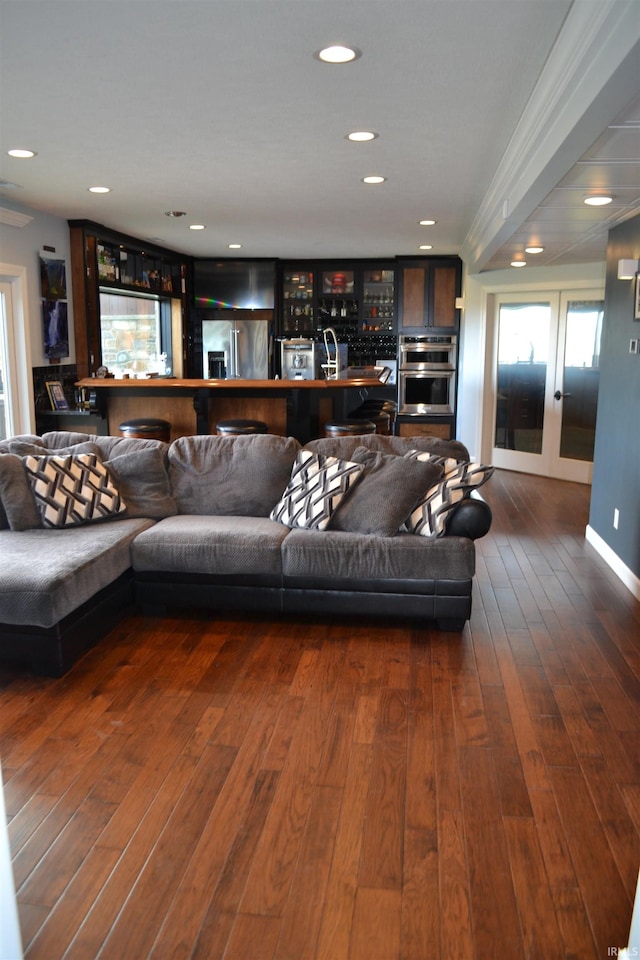 living room featuring dark hardwood / wood-style floors and crown molding