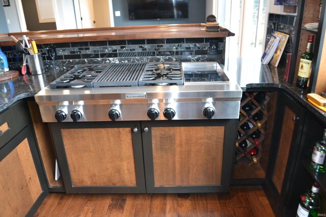 kitchen featuring backsplash and dark hardwood / wood-style floors