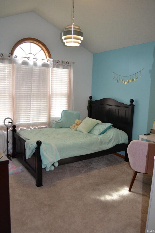 bedroom featuring carpet and vaulted ceiling