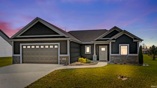 craftsman house with a yard and a garage