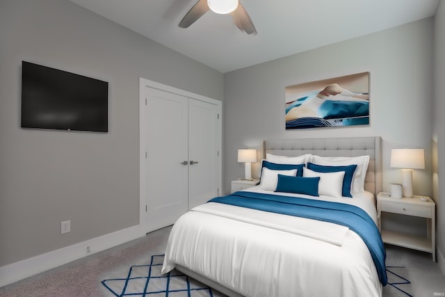 bedroom featuring a closet, light colored carpet, and ceiling fan