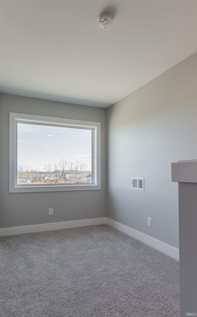 carpeted empty room featuring plenty of natural light