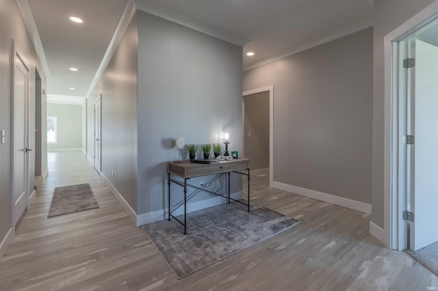 corridor with crown molding and light hardwood / wood-style flooring